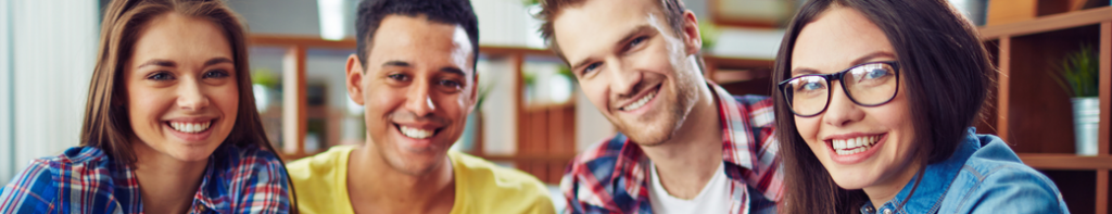 Diverse group of four smiling high school students.