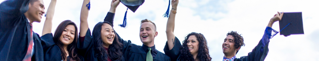 Diverse group of high school graduates celebrating in their caps and gowns.