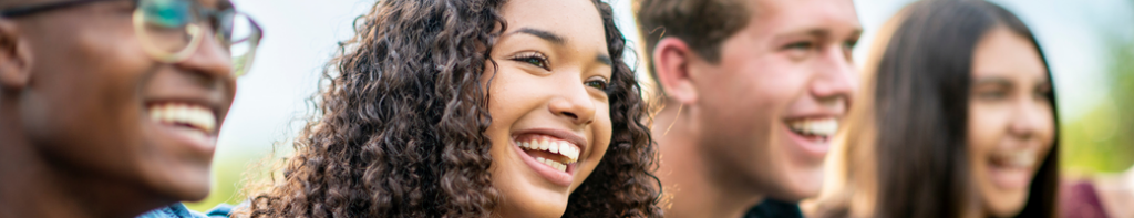 diverse group of teens laughing and smiling